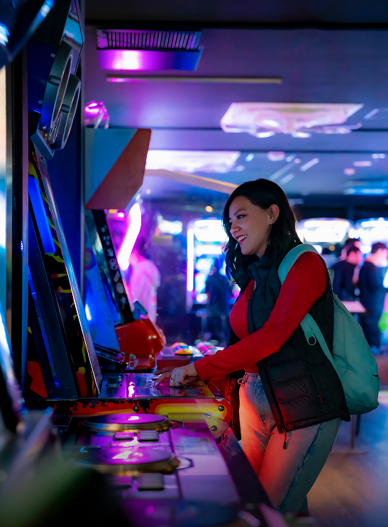 Woman playing arcade game in neon-lit room