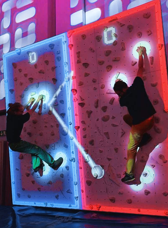 Indoor climbing competition with glowing walls